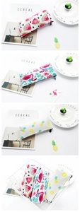 Detail of canvas pencil cases featuring flamingo, watermelon, and pineapple prints
