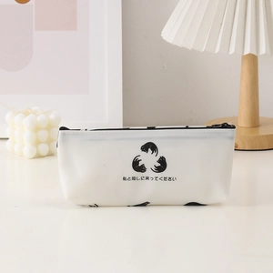 Close-up of white silicone cat pencil case with black zipper in minimalist desk setting