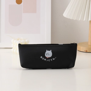 Detail of black silicone pencil case with cute cartoon cat face and zipper closure