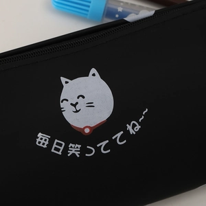 Detail of black silicone pencil case with cute white cartoon cat and Japanese lettering