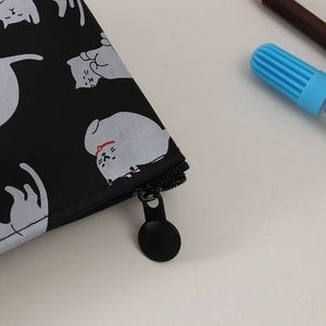 Close-up of black cat pencil case with round metal zipper and waterproof texture