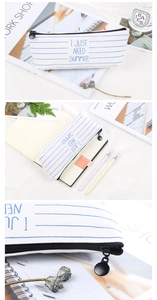 Detail view of striped canvas pencil case with zipper and large storage interior