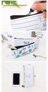 Detail view of canvas pencil case showing dimensions 19x7.5cm and smooth zipper pull