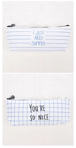 Detail of blue grid and striped canvas pencil cases with zipper and slogan prints