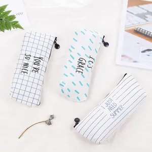 Three-piece minimalist blue canvas pencil cases with stripe, grid, and dash patterns