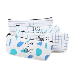 Set of four blue and white canvas pencil cases with stripes and geometric patterns