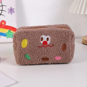 Detailed view of brown plush pencil case featuring cute monster embroidery and zipper