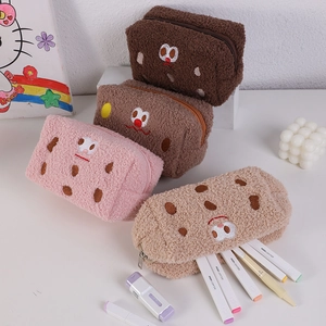 Detail of plush sandwich cookie pencil cases in four colors showing zipper and soft texture