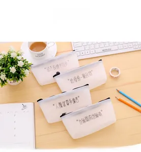 Detailed view of four translucent jelly pencil pouches with funny text on a desk