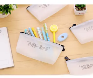 Detail of translucent triangular pencil cases with fun quotes and large capacity storage