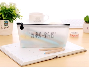 Translucent frosted pencil case with Chinese text on desk with stationery and plants