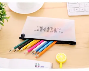 Detail of translucent pencil case with black text on a wooden desk with stationery