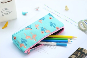 Detailed view of flamingo mint canvas pencil case with pink zipper and stationery inside