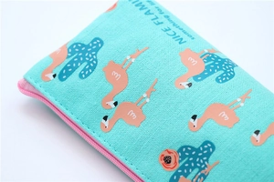 Detailed close-up of canvas texture and stitching on the blue flamingo zipper pouch