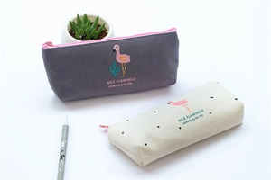 Detail of flamingo canvas pencil cases with pink zipper closure and cute cactus patterns