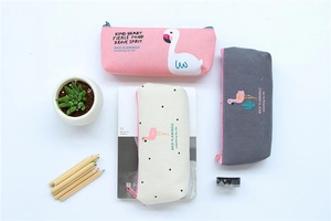 Detailed flat lay of three flamingo canvas pencil cases with motivational quotes