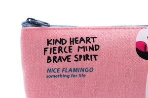 Detailed close-up of pink canvas material with flamingo print and motivational quotes
