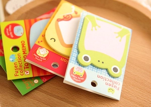 Detailed view of cartoon animal sticky notes in retail packaging on a wooden tray