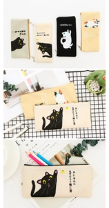 Detailed view of canvas cat pencil cases with Japanese illustrations and metal zippers