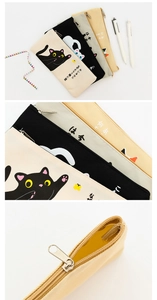 Detail of canvas cat pencil cases showing metal zippers and cute feline illustrations