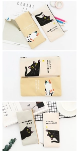 Macro detail of canvas cat pencil cases with metal zippers and minimalist illustrations