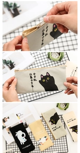 Detail of metal zipper and canvas texture on a minimalist cartoon cat pencil pouch
