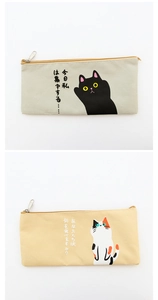 Close-up of minimalist cat canvas pencil cases featuring smooth zippers and Japanese text