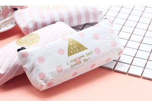 Detailed view of pink striped canvas pencil cases with gold lettering and zipper closure