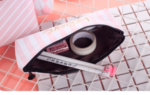 Pink and white striped canvas pencil case with golden believe text and stationery items
