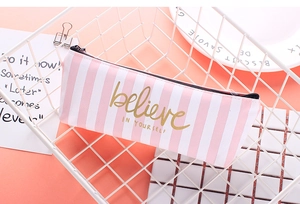 Detail of pink striped canvas pencil case with gold believe in yourself lettering