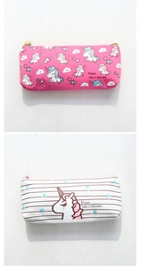 Detailed view of unicorn canvas pencil cases in pink and white with heart zippers