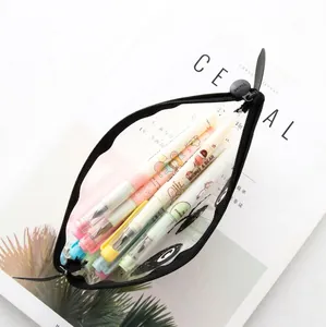Transparent PVC pencil case with cute animal prints and colorful pens inside on a magazine
