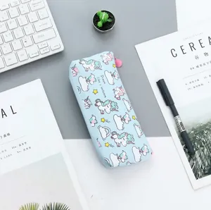Cute blue unicorn canvas pencil case with zipper shown on a minimalist desk setup