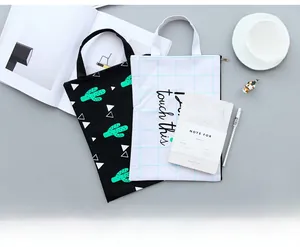 Detail of canvas document bags with cactus print and grid patterns for stationery storage