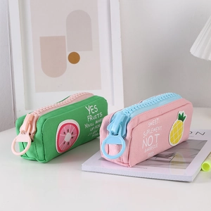 Detail of fruit canvas pencil bags with large colorful zippers and patch patterns