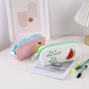 Detail of canvas fruit pencil cases with oversized zippers and cute pineapple patterns