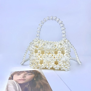 Detail of handmade pearlescent and acrylic floral beaded bag with detachable shoulder strap
