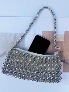 Silver beaded handmade shoulder bag with pearl-style chain showing phone storage capacity
