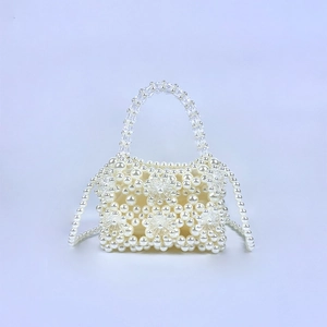 Detailed view of handmade flower pearl beads and clear acrylic crystals on mini bag
