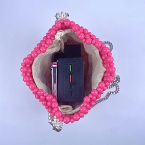 Detail showing pink pearl woven bucket bag interior capacity with fabric lining
