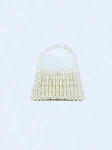Close-up of handmade white pearl woven handbag with detailed bead texture and arched handle