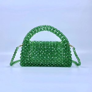 Elegant emerald green beaded woven pillow handbag with a detachable crossbody strap