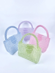 Close-up of handmade mini acrylic beaded tote bags in assorted candy colors