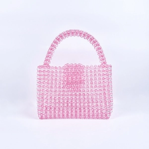 Detailed close-up of pink and clear acrylic beads on a handmade woven mini bag