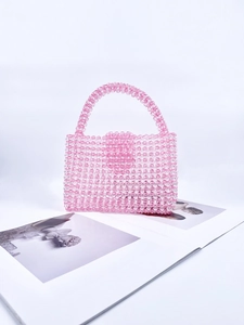 Macro view of pink handmade acrylic beaded handbag with translucent candy color finish