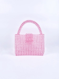 Close-up of pink and clear acrylic beads on a handmade woven candy-colored handbag