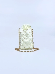 Detailed view of mini chain bag featuring acrylic discs and satin drawstring pouch