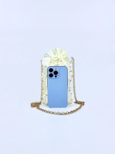 Detailed size comparison of the mini transparent sequin bag with a smartphone and gold chain