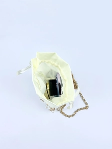 Interior view showing phone and lipstick capacity in white satin sequin drawstring bag