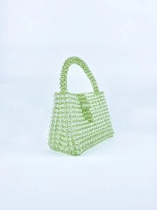 Detail of green acrylic beaded handbag with clear beads and handwoven texture